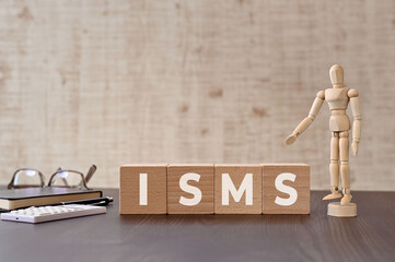There is wood cube with the word ISMS. It is eye-catching image.