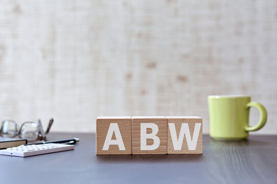 There Is Wood Cube With The Word ABW. It Is An Acronym For Activity Based Working An Eye-catching Image.