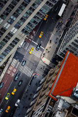 New York, USA - April 26, 2022: Yellow taxi cabs in New York City. Looking down on skyscrapers and...