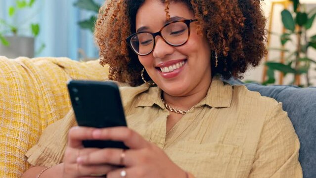 Funny, phone and black woman laughing on sofa for social media, text or meme in her home. Online, comic and girl relax with smartphone on couch, chatting or reading post or update in a living room
