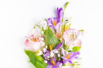bouquet of spring flowers flat lay on a white background. Top view and copy space.