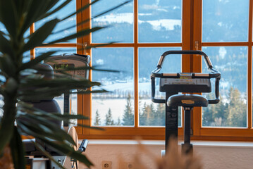 Cardio exercise equipment in front of window at empty luxury hotel