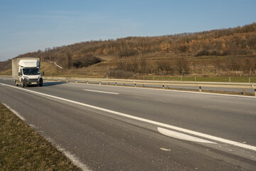 Truck with container on highway, cargo transportation concept. 