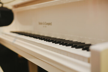 White Baby Grand Piano, Close up with Bokeh