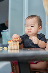 誕生日ケーキを食べる１歳の男の子