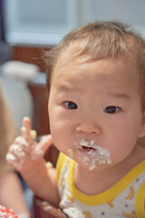 生クリームを食べる１歳の男の子