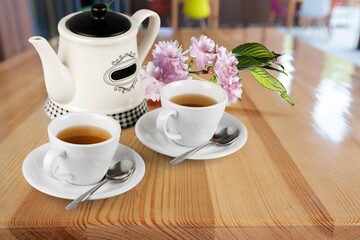 Tea concept, teapot and cups on the desk