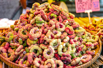 Freshly picked tamarind from the orchard stacked on bamboo baskets for sale in Bang Nam Phueng floating market, Thailand.