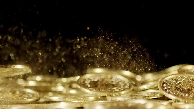 Shiny golden coins falling with sparkling golden dust. Symbolizing wealth, fortune, and prosperity.