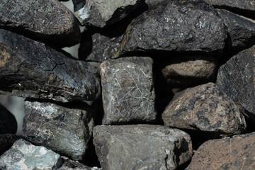 A loosely stacked rock wall, made out of pieces of serpentine at a beach in San Francisco.