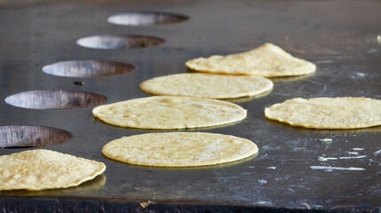 Fototapeta na wymiar homemade tortillas baking on the griddle