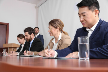 Business conference. People working at wooden table in meeting room