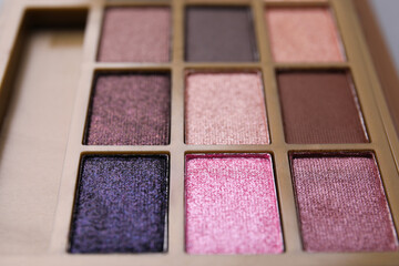 Beautiful eyeshadow palette as background, closeup. Professional cosmetic product