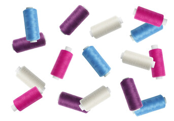 Many colorful sewing threads falling on white background