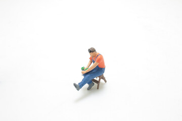 Obraz premium mini worker figure on working with tool