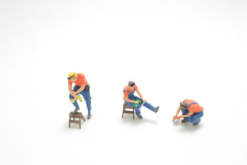 mini worker figure on working with tool