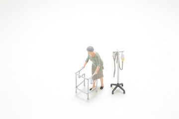 a mini figure Elderly woman using walking frame