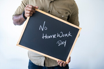 No home work day concept, person holding a board with concept written with chalk Selective focus