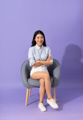 image of girl sitting on sofa  isolated on purple background