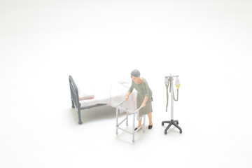 a mini figure Elderly woman using walking frame