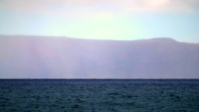Hawaii ocean surface mountain background slow motion