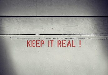 Wall with text inscription KEEP IT REAL, means to be true and authentic,express whole self...
