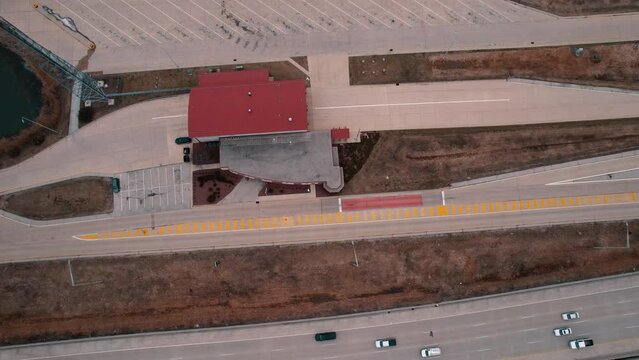 top down aerial of Truck Weigh Station next to Interstate. Department of Trasportation place where they pull truck drivers for safety inspection. Scale for vehicles. Wisconsin, USA 4k