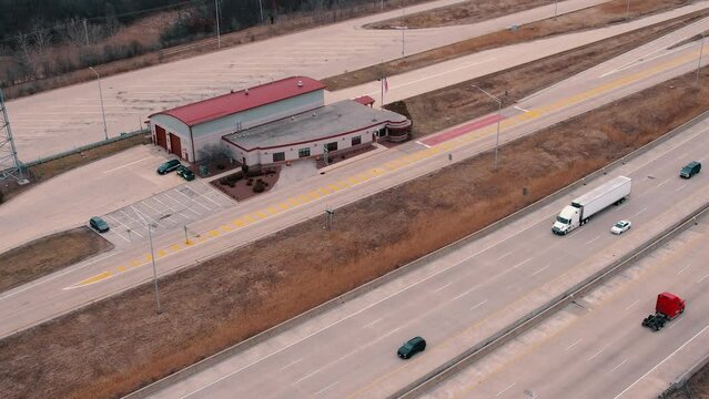 State Troopers cars parked at the Truck Weigh Station next to Interstate. Department of Trasportation place where they pull truck drivers for safety inspection. Scale for vehicles. Wisconsin, USA 4k