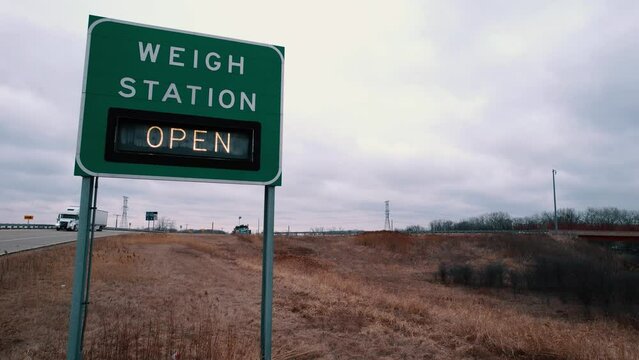 closeup of Wigh Station road sign that indicates is open. Semi Trucks needs to pull over for inspection. Wisconsin USA 4k