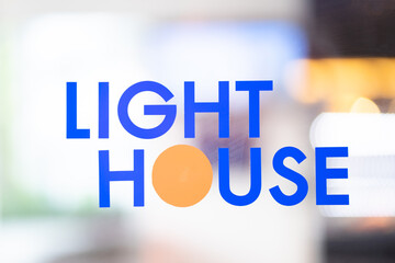 The text LIGHT HOME on the background uses a light effect