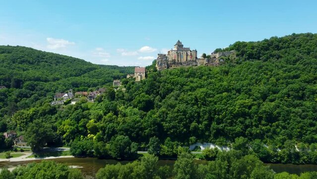 4K aerial footage of the Chateau de Castelnaud-la-Chapelle, which is a medieval fortress in the commune of Castelnaud-la-Chapelle, overlooking the river Dordogne in P&eacute;rigord, Southern France.