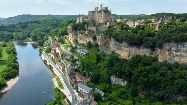 Smooth 4K aerial footage of Beynac-et-Cazenac, a beautiful hillside village located in the Dordogne department in southwestern France