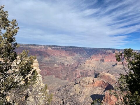Scenic photo of the Grand Canyon, with blue skies and clouds. 