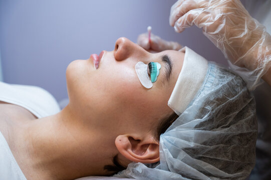 Close-up portrait of a woman on eyelash lamination procedure. 