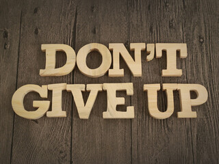Don't give up, text words typography written with wooden letter, life and business motivational inspirational