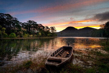Fototapeta premium A lonely boat during a beautiful sunset and nice reflection