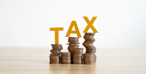 Word tax with stacked coins, There are scattered coins. Tax Concept.
