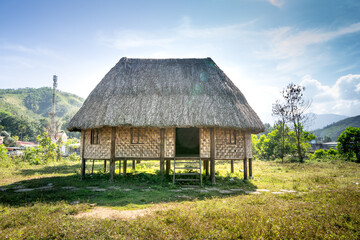 Fototapeta na wymiar Rong house in Bahnar villages in Highland Vietnam. Rong house is used as a place to organize festivals, village meetings, is the communal house of Bahnar, Jar