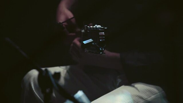 Guitarist plays flamenco at a dark scenario at tablao in Spain