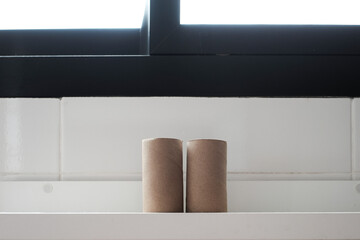 Empty tissue paper roll in bathroom.