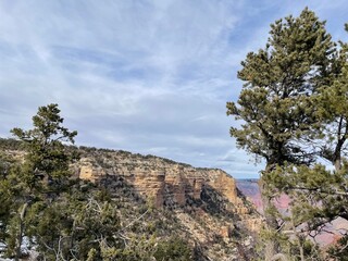 Grand Canyon, with blue sky, clouds, trees.