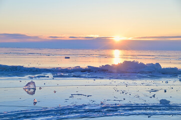 Transparent Ice Surface of Frozen Lake Baikal During Sunrise