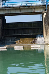 side view of river dam with road on top of the dam