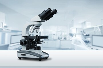 Modern microbiology microscope on table in laboratory.
