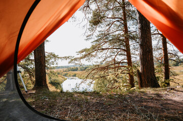 Camping. View from the tent to the surrounding landscape. Outdoor recreation.