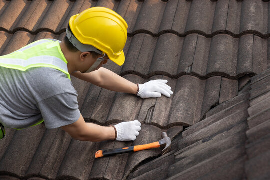 crew replacing shingles