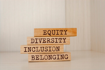 Equity, diversity, inclusion and belonging symbol. Wooden blocks with words 'equity, diversity,...