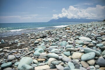 Fototapeta na wymiar Close-up of blue stones on the beach of Pantai Batu Biru, the Blue Stone Beach, in Ende on Flores.