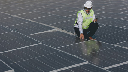 The portrait of a asian young engineer checks photovoltaic solar panels. Concept. renewable energy technology electricity service, green power.