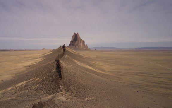 An aerial view of Shiprock an example of a volcanic neck or monadnock rises nearly 1,583 feet above the high desert plain of the Navajo Nation in New Mexico.
